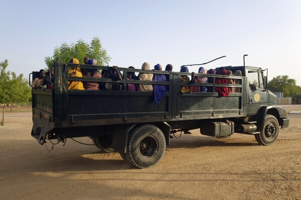 FILE - Women and children who were held captive by islamic extremists, and rescued by Nigeria's army, are seen upon arrival in Maiduguri, Nigeria, May 20, 2024. Dozens of women and young girls were unlawfully detained and abused in Nigerian military detention facilities after escaping captivity from Boko Haram extremists in the country’s northeast, Amnesty International said in a new report on Monday. (AP Photo/Jossy Olatunji, File)