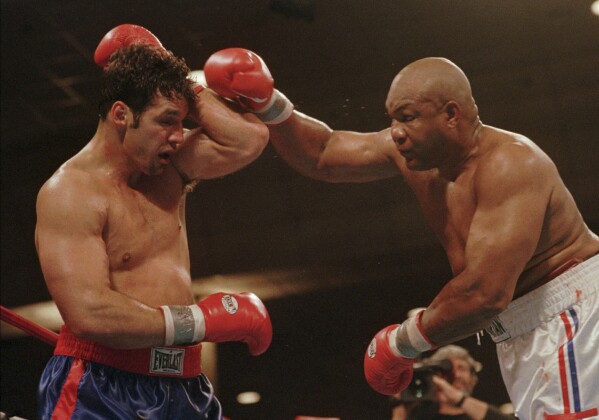 Lou Savarese of New York City blocks a right from George Foreman during their scheduled 12 round bout at the Atlantic City Convention Hall in Atlantic City, N.J., Saturday, April 26, 1997. (AP Photo/B.Vartan Boyajian, File)