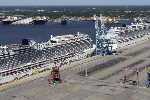 FILE - In this May 4, 2020 file photo, Norwegian cruise ships are docked at Portsmouth Marine Terminal in Portsmouth, Va. Norwegian Cruise Lines is threatening to skip Florida ports because of the governor's order banning businesses from requiring that customers be vaccinated against COVID-19. The company says Gov. Ron DeSantis' order conflicts with guidelines from federal health authorities that would let cruise ships sail in U.S. waters if passengers and crew members are vaccinated.  (Stephen M. Katz/The Virginian-Pilot via AP, File)