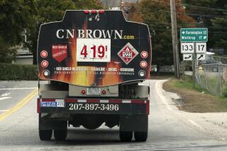 FILE - A fuel delivery truck advertises its price for a gallon of heating oil, Oct. 5, 2022 in Livermore Falls, Maine. The Labor Department releases the Producer Price Index for October on Tuesday. (AP Photo/Robert F. Bukaty, File)