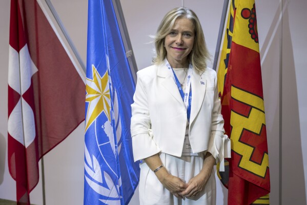 FILE - Celeste Saulo, of Argentin, a poses after she was elected as Secretary-General of the World Meteorological Organization (WMO) in Geneva, Switzerland, June 1, 2023 during the U.N. climate and weather agency's congress in Geneva. The new head of the United Nations weather agency said Tuesday that strengthening early warning systems that monitor when and where extreme weather will happen is a key priority area for her administration that will help reduce the risk of natural disasters that are exacerbated by climate change. (Martial Trezzini/Keystone via AP, File)