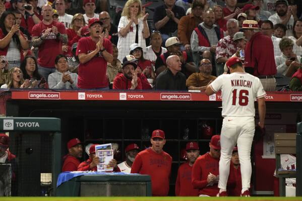 Fans applaud as Los Angeles Angels starting pitcher Yusei Kikuchi walks back to the dugout after being taken out during the sixth inning of a baseball game against the Miami Marlins, Friday, May 23, 2025, in Anaheim, Calif. (AP Photo/Mark J. Terrill)