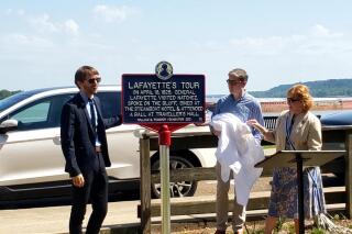 Julien Icher, left, the founder of The Lafayette Trail Inc., Historic Natchez Foundation Executive Director Carter Burns, center, and Hellen Hicks Polk, State Regent of the Mississippi State Society Daughters of the American Revolution, unveil a Lafayette's Tour marker on Silver Street in Natchez, Miss., on Wednesday, June 16, 2021. 
The city is now part of a trail commemorating what was then a nationwide tour by a general who had fought in both the American and French revolutions.   (Sabrina Robertson/The Natchez Democrat via AP)