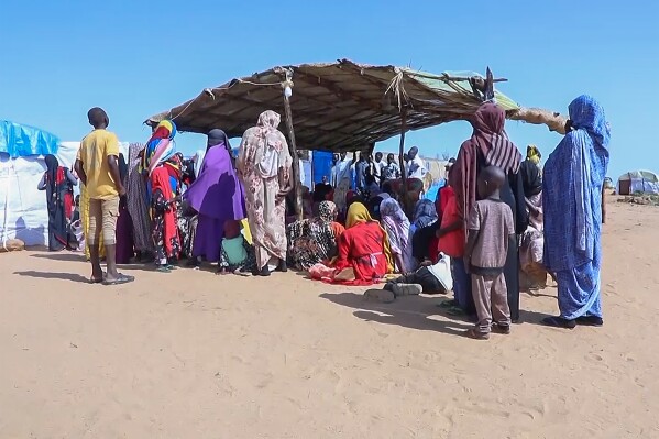 FILE - Sudanese refugees gather outside a field hospital in Acre, Chad, Aug. 15, 2023. The United Nations food agency has warned that it might end food assistance to 1.4 million refugees in Chad who fled the conflict in parts of the Sahel because of limited funding. The World Food Program says most of the refugees escaped the war in Sudan and crossed into Chad in the last six months in numbers not seen in the last 20 years. (AP Photo, File )