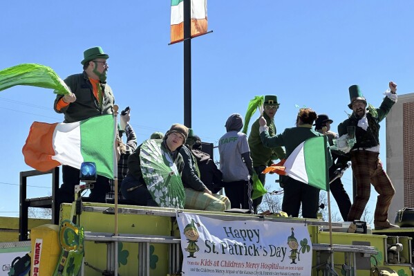 People celebrate the St. Patrick's Day parade on Sunday, March 17, 2024, in Kansas City, Mo. This year's theme was "50 Cheers for 50 Years." The parade marks one of the first mass gatherings following the deadly shooting at last month's Super Bowl champion Chiefs rally in Kansas City. (APhoto/Nick Ingram)