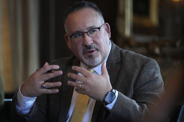 U.S. Education Secretary Miguel Cardona participates in a roundtable discussion with students from Dartmouth College, Wednesday, Jan. 10, 2024, on the school's campus, in Hanover, N.H. (AP Photo/Steven Senne)