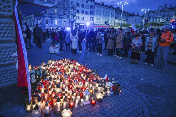 FILE - Friends and residents gather to place candles and flowers in honor of Damian Soból, a Polish food aid worker who was killed with six other World Central Kirchen workers by Israeli airstrike in Gaza this week, in Soból's hometown of Przemysl, in southeastern Poland, on Thursday, April 4, 2024. World Central Kitchen and a few other aid groups suspended operations in Gaza, after seven aid workers were killed by airstrikes. Yet despite the danger, many of the largest organizations barely slowed down. Hunger has become commonplace in Gaza amid the war with Israel, and U.N. officials warn that famine is increasingly likely in northern Gaza. (AP Photo, File)
