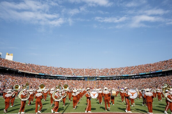 FILE - The Texas band performs on the field before an NCAA college football game against Oklahoma at the Cotton Bowl, Saturday, Oct. 8, 2022, in Dallas. The Big 12 is losing its marquee matchup when the Red River Rivalry is played Saturday for the final time under the league’s umbrella.(AP Photo/Jeffrey McWhorter, File)