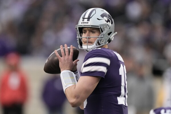 FILE - Kansas State quarterback Will Howard looks to pass during the second half of the team's NCAA college football game against Baylor on Nov. 11, 2023, in Manhattan, Kan. Howard announced his intention to transfer to Ohio State on Thursday night, Jan. 4, giving the Buckeyes a replacement for Kyle McCord after his own decision to transfer to Syracuse. Howard made the announcement on his social media channels. (AP Photo/Charlie Riedel, File)