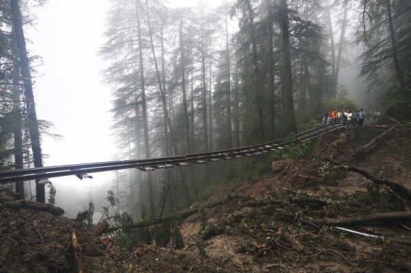 A portion of the Shimla-Kalka heritage railway track that got washed away following heavy rainfall on the outskirts of Shimla, Himachal Pradesh state, Monday, Aug.14, 2023. Heavy monsoon rains triggered floods and landslides in India's Himalayan region, leaving more than a dozen people dead and many others trapped, officials said Monday. (AP Photo/ Pradeep Kumar)