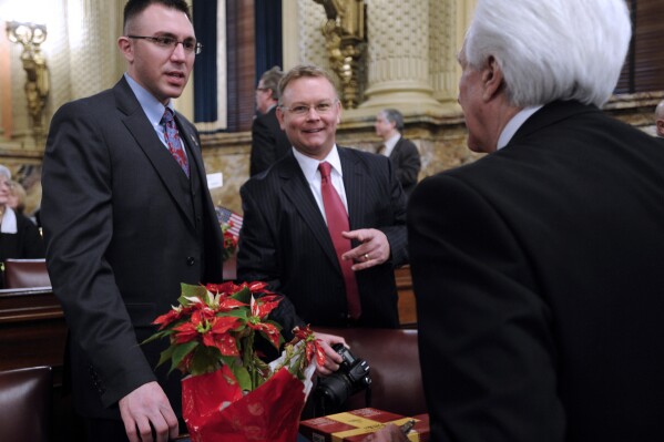 FILE - Pennsylvania Rep. Ryan Bizzarro, D-Erie, left, meets with fellow House members Rep. Patrick Harkins, D-Erie, center and Rep. Florindo Fabrizio, D-Erie, right, prior to being sworn into office, Jan. 1, 2013 in Harrisburg, Pa. The Democratic Pennsylvania state lawmaker has announced he plans to run for treasurer, positioning himself as an ideological opposite to the Republican incumbent regarding abortion access and the 2020 election. Rep. Bizzarro announced his candidacy Tuesday, Sept. 26, 2023 in next year's primary. First-term incumbent Stacy Garrity, a Republican, has said she plans to run for a second term. (AP Photo/Bradley C Bower, file)