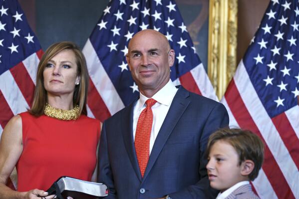 Rep. Jake Ellzey, R-Texas, joined by his wife Shelby, left, center, and their children, are seen after his wearing-in ceremony, at the Capitol in Washington, Friday, July 30, 2021. Ellzey won a special election in Texas's 6th congressional district which represents three counties just south of the Dallas-Fort Worth metropolitan region. (AP Photo/J. Scott Applewhite)