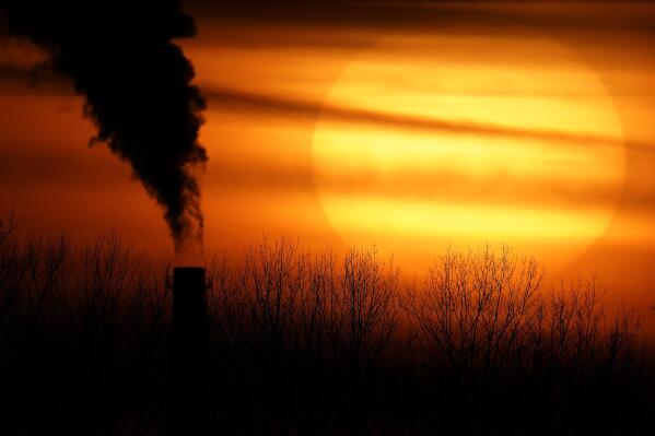 FILE - Emissions from a coal-fired power plant are silhouetted against the setting sun in Kansas City, Mo., Feb. 1, 2021. A federal appeals court has put Environmental Protection Agency regulations on hold Friday, May 26, 2023, aimed at reducing air pollution in Missouri, drawing criticism from environmentalists but praise from the state's attorney general who called the proposal “unconstitutional overreach.” (AP Photo/Charlie Riedel, File)