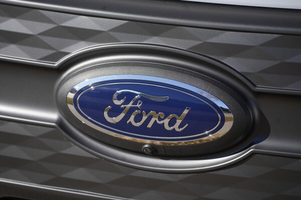 FILE - The Ford company logo is shown on Thursday, Nov. 25, 2022, outside a Ford dealership in southeast Denver. Ford is recalling more than 238,000 Explorers in the U.S. because a rear axle bolt can fail, potentially causing a loss of drive power or allowing the SUVs to roll away while in park. The recall on Friday, Oct. 13, 2023, comes after U.S. safety regulators opened an investigation into the problem after getting two complaints that repairs didn’t work in two previous recalls this year and in 2022. (AP Photo/David Zalubowski, File)