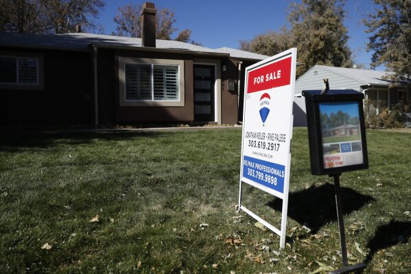 FILE - In this Oct. 22, 2019, file photo a sign stands outside a home for sale in southeast Denver. On Thursday, Feb. 20, 2020, Freddie Mac reports on this week's average U.S. mortgage rates. (AP Photo/David Zalubowski, File)