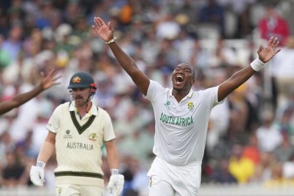 South Africa's Lungi Ngidi, right, celebrates the dismissal of Australia's Beau Webster on day two of the World Test Championship final between South Africa and Australia at Lord's cricket ground in London, Thursday, June 12, 2025. (AP Photo/Kirsty Wigglesworth)