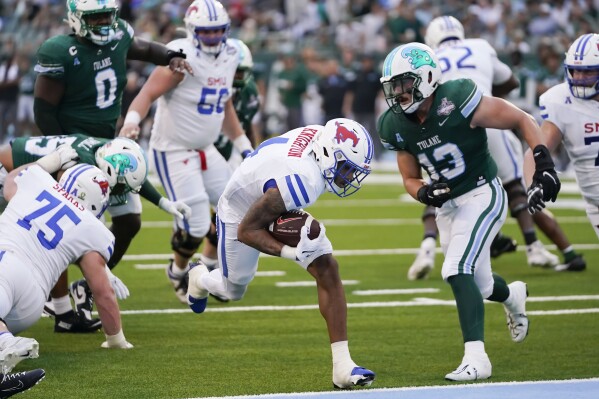 SMU running back Jaylan Knighton (4) carries against Tulane linebacker Tyler Grubbs (13) for a touchdown during the first half of the American Athletic Conference Championship NCAA college football game , Saturday, Dec. 2, 2023 in New Orleans. (AP Photo/Gerald Herbert)