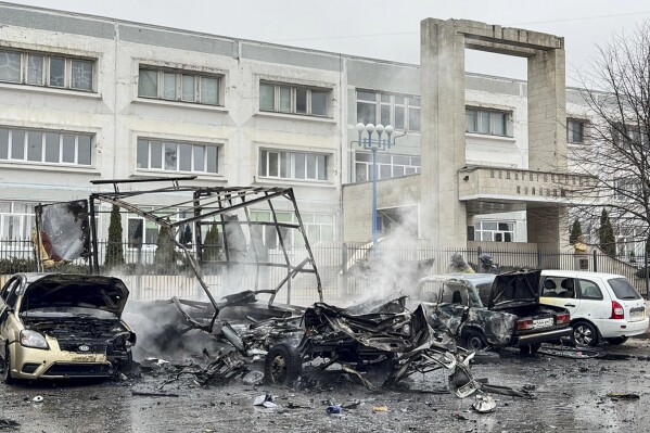 This photo released by Belgorod region governor Vyacheslav Gladkov's telegram channel on Saturday, March 16, 2024, shows broken and burned cars after shelling from the Ukrainian side, in Belgorod, Russia. A Russian regional governor says two people have been killed in Ukrainian shelling of the city of Belgorod, close to the border with Ukraine. Three others were wounded. (Belgorod region governor Vyacheslav Gladkov telegram channel via AP)