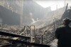 In this grab taken from video released by Investigative Committee of Russia on Saturday, March 23, 2024, an investigators from the Investigative Committee of Russia examines the burned concert hall after an attack on the building of the Crocus City Hall on the western edge of Moscow, Russia. Russia's top state investigative agency says the death toll in the Moscow concert hall attack has risen to over 133. The attack Friday on Crocus City Hall, a sprawling mall and concert venue on Moscow's western edge, also left many wounded and left the building a smoldering ruin.(Investigative Committee of Russia via AP)