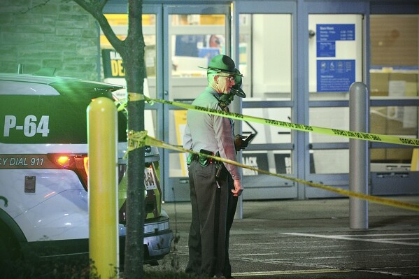 Police respond to the scene of a shooting on Monday, Nov. 20, 2023 in Beavercreek, Ohio. Police say a shooter opened fire at a Walmart, wounding four people before apparently killing himself. The attack took place Monday night at a Walmart in Beavercreek, in the Dayton metropolitan area. (Marshall Gorby/Dayton Daily News via AP)