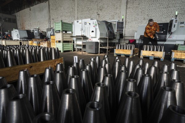 A worker stores mortar shells at a factory in Ukraine, on Wednesday, January 31, 2024. (AP Photo/Evgeniy Maloletka)