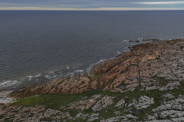Waves from Hudson Bay crash onto shore, Wednesday, Aug. 7, 2024, in Churchill, Manitoba. (AP Photo/Joshua A. Bickel)
