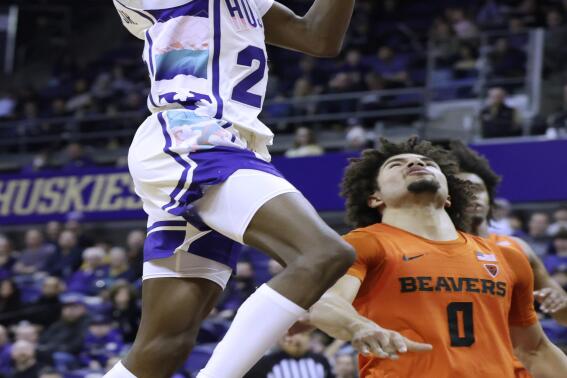 Washington guard Keyon Menifield goes to the basket against Oregon State guard Jordan Pope during the second half of an NCAA collage basketball game Saturday, Feb. 18, 2023, in Seattle. (AP Photo/John Froschauer)
