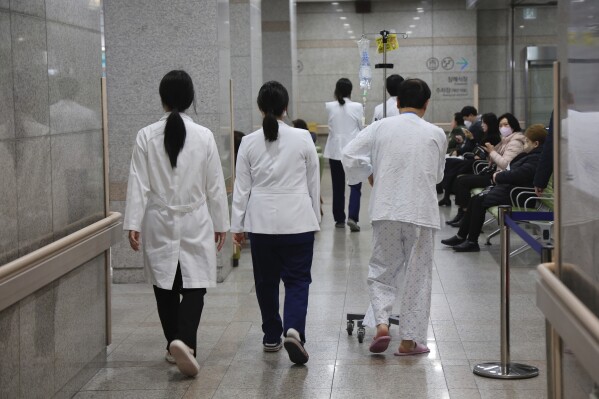 Medical workers walk inside a general hospital in Incheon, South Korea, Monday, March 11, 2024. South Korea's government expressed deep regret over the news that some senior doctors could join the protracted walkouts by thousands of junior doctors, saying Tuesday, March 12, the people won’t understand another collective action that threatens the lives of patients.(Lim Soon-seok/Yonhap via AP)