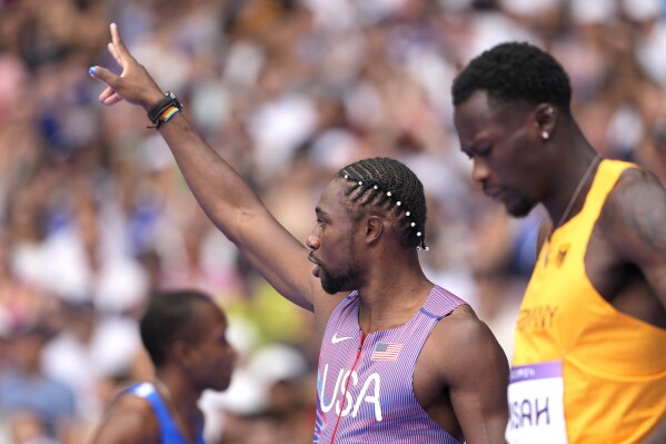 Noah Lyles, of the United States, gestures ahead of his heat in the men's 100-meters at the 2024 Summer Olympics, Saturday, Aug. 3, 2024, in Saint-Denis, France. (AP Photo/Bernat Armangue)