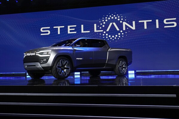 FILE - The Ram 1500 Revolution electric battery powered pickup truck is displayed on stage during the Stellantis keynote at the CES tech show on Jan. 5, 2023, in Las Vegas. Tensions rose in contract talks between the United Auto Workers union and Stellantis on Tuesday, Aug. 8, with the union president accusing the company of seeking concessions in contract talks when the union wants gains, as a September strike threat looms. (AP Photo/John Locher, File)