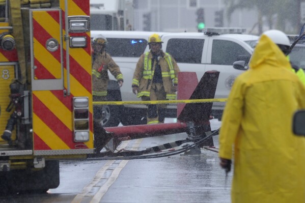 FILE - A portion of the tail section of a helicopter is shown after crashing in Kailua, Hawaii, Monday, April 29, 2019. The Federal Aviation Administration said Friday, Aug. 4, 2023, that it is setting up a new process for air tour operators in Hawaii to be approved to fly at lower altitudes after numerous fatal crashes in recent years. (Bruce Asato/Honolulu Star-Advertiser via AP, File)