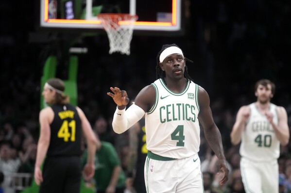 Boston Celtics guard Jrue Holiday (4) celebrates after hitting a 3-point basket during the first half of an NBA basketball game against the Utah Jazz, Friday, Jan. 5, 2024, in Boston. (AP Photo/Charles Krupa)