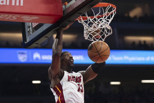 Miami Heat center Bam Adebayo scores in the first quarter of an NBA basketball game against the Sacramento Kings in Sacramento, Calif., Monday, Feb. 26, 2024. (AP Photo/José Luis Villegas)