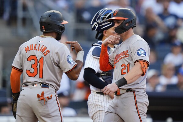 Baltimore Orioles' Cedric Mullins (31) celebrates with Austin Hays (21) after they scored on a home run by Hays against the New York Yankees during the seventh inning of a baseball game Thursday, June 20, 2024, in New York. (AP Photo/Frank Franklin II)