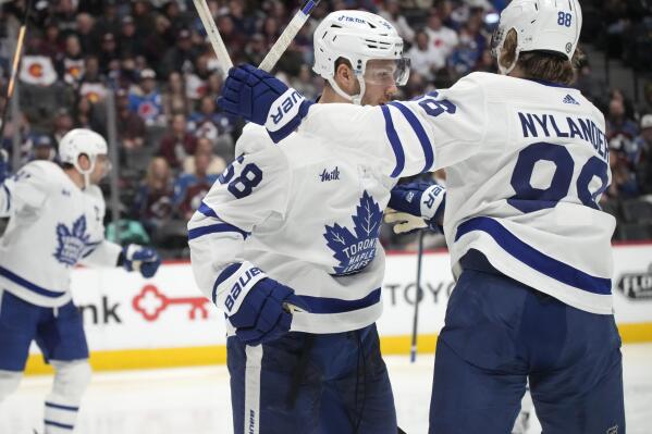 Toronto Maple Leafs left wing Michael Bunting, front left, is congratulated after scoring a goal by right wing William Nylander in the second period of an NHL hockey game against the Colorado Avalanche, Saturday, Dec. 31, 2022, in Denver. (AP Photo/David Zalubowski)