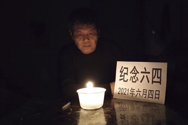 In this photo taken June 4, 2021 and released by Chen Siming, Chen Siming poses for photos with a paper which reads 