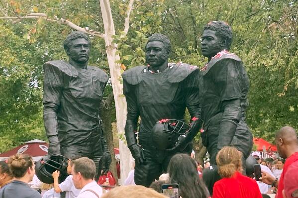 The University of Oklahoma dedicated a statue honoring the Selmon brothers — defensive linemen Lucious, Dewey and Lee Roy — on Saturday, Sept. 24, 2022, in Norman, Okla. The trio starred for Oklahoma from 1971 to 1975 and helped the Sooners compile a 54-3-1 record with national championships in 1974 and 1975 and four Big Eight titles.  (AP Photo/Cliff Brunt)
