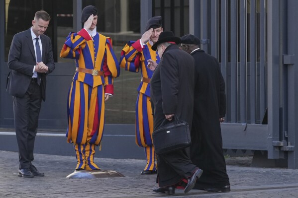 Cardinals, right, arrive for a meeting of cardinals, at the Vatican, Tuesday, April 22, 2025. (AP Photo/Andrew Medichini)