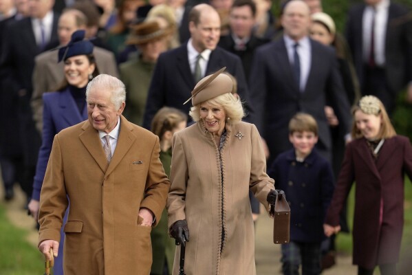 FILE - Britain's King Charles III and Queen Camilla arrive to attend the Christmas Day service at St Mary Magdalene Church at Sandringham in Norfolk, England, Monday, Dec. 25, 2023. Queen Camilla, once Seen as the scourge of the House of Windsor, the woman at the center of King Charles III's doomed marriage to the late Princess Diana, has become one of the monarchy's most prominent emissaries.  With Charles and the Princess of Wales sidelined by illness, Camilla has stepped lightly into the void, increasing her appearance schedule and taking on the important role of keeping the royal family firmly in the public eye, to be seen.  (AP Photo/Kin Cheung, File)