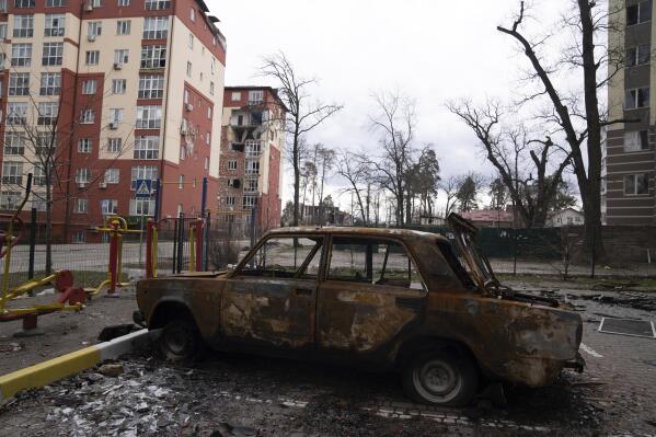 A damaged by shelling car is seen in a yard in Irpin, in the outskirts of Kyiv, Ukraine, Monday, April 11, 2022. (AP Photo/Evgeniy Maloletka)