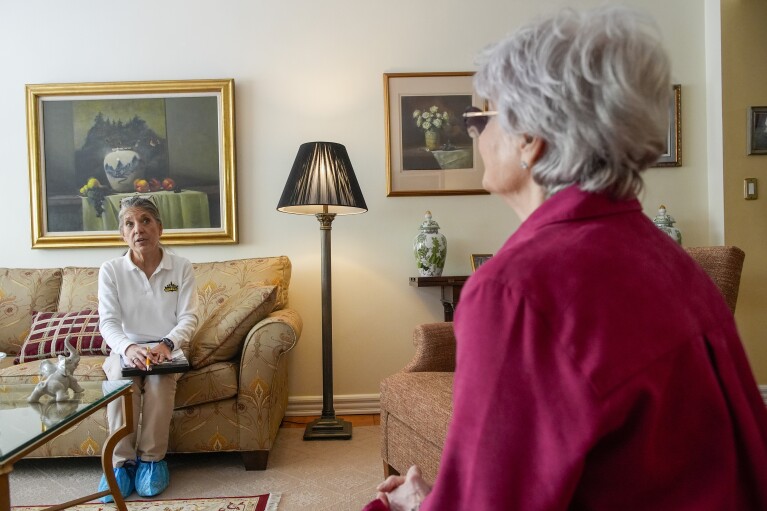 Dr. Amy Attas, left, talks with Lisa Healey about Cody Healey, an 8 year old male Maltese's, symptoms during a house call, Tuesday, April 23, 2024, in New York. (ĢӰԺ Photo/Mary Altaffer)