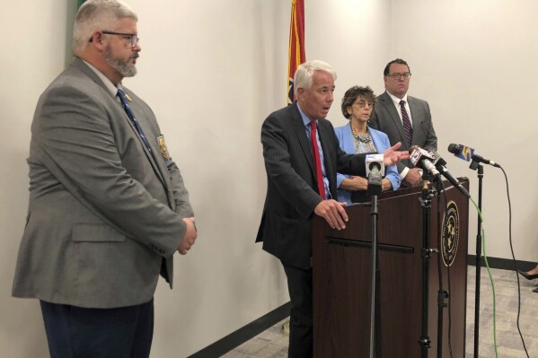 Shelby County District Attorney Steve Mulroy, second left, speaks with reporters about the decision to decline to pursue criminal charges against a Memphis Police Department officer in the fatal shooting of 20-year-old Jaylin McKenzie on Tuesday, Sept. 26, 2023, in Memphis, Tenn. (AP Photo/Adrian Sainz)