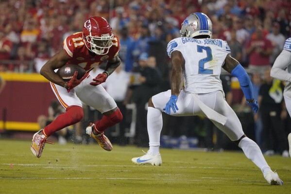 Kansas City Chiefs wide receiver Marquez Valdes-Scantling (11) runs with the ball as Detroit Lions safety C.J. Gardner-Johnson (2) defends during the first half of an NFL football game Thursday, Sept. 7, 2023, in Kansas City, Mo. (AP Photo/Ed Zurga)