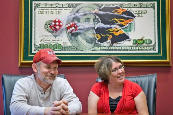 FILE - Powerball lottery winners David, left, and Erica Harrig, of Gretna, Neb., speak during an interview at the law office of their attorney Darren Carlson in Omaha, Neb., on Dec. 13, 2013. (Kent Sievers /Omaha World-Herald via AP, File)