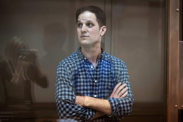 FILE - Wall Street Journal reporter Evan Gershkovich stands in a glass cage in a courtroom at the Moscow City Court, in Moscow, Russia, April 18, 2023. Gershkovich, who was detained on espionage charges, arrived at a Moscow court Thursday, Aug. 24, for a hearing on a motion by the prosecution to extend his arrest. (AP Photo/Alexander Zemlianichenko, File)