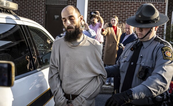 Cody Balmer is escorted from court after his arraignment Monday, April 14, 2025, in Harrisburg, Pa. (Dan Gleiter/The Patriot-News via AP)
