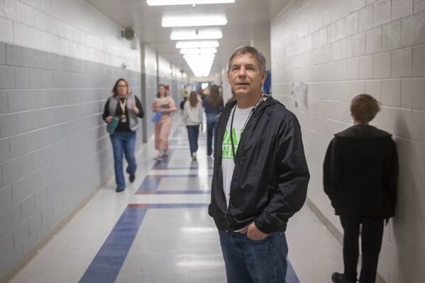 This image provided by Idaho Education News shows Ernie Chavez, a volunteer with Dads on Duty, posing for a photo at Rigby Middle School in Rigby, Idaho on Wednesday, Feb. 5, 2025. (Roark/Idaho Education News via AP)