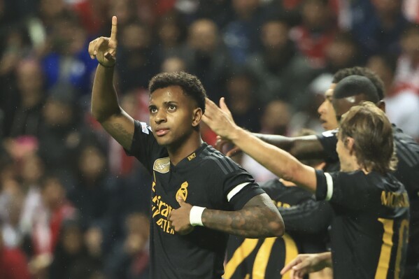 Real Madrid's Rodrygo, left, celebrates after scoring the opening goal during the Champions League group C soccer match between SC Braga and Real Madrid at the Municipal stadium in Braga, Portugal, Tuesday, Oct. 24, 2023. (AP Photo/Luis Vieira)