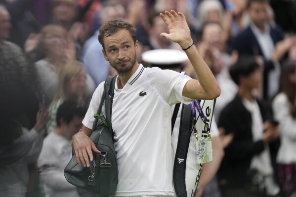 Russia's Daniil Medvedev leaves the court after losing to Spain's Carlos Alcaraz in their men's singles semifinal match on day twelve of the Wimbledon tennis championships in London, Friday, July 14, 2023. (AP Photo/Alberto Pezzali)