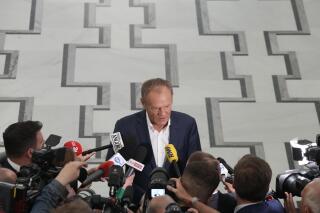 Poland's opposition leader and former prime minister, Donald Tusk, talks to reporters in Warsaw, Poland, Friday, May 26, 2023. Poland's lawmakers have approved a contentious law targeting the opposition. Critics say the law approved Friday violates a number of provisions in Poland's constitution and is a clear example of how the right-wing ruling party is using the law to its own ends. (AP Photo/Czarek Sokolowski)